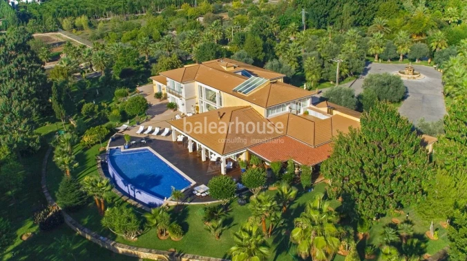 Impressive villa with noble architecture on a large plot of land surrounded by the green landscape.