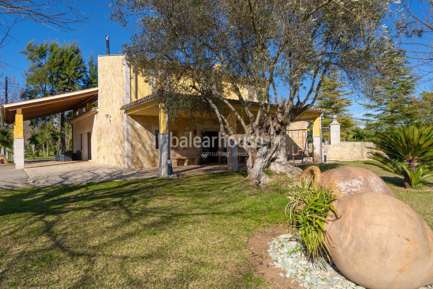 Impressive villa with noble architecture on a large plot of land surrounded by the green landscape.